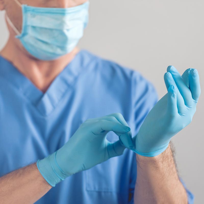 Doctor putting on nitrile gloves