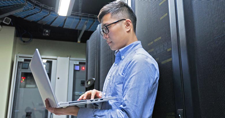Chinese IT engineer working in a server room